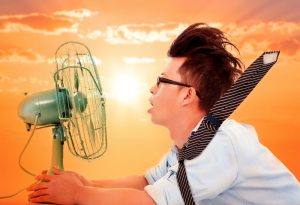 hot man sitting in front of fan