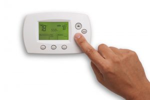 Digital Thermostat with a male hand, set to 78 degrees Fahrenheit. Saved with clipping path for thermostat and hand combined.